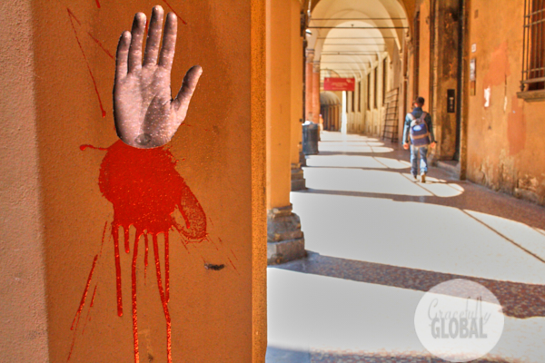 A portico with graffiti of a hand in Bologna, Italy.